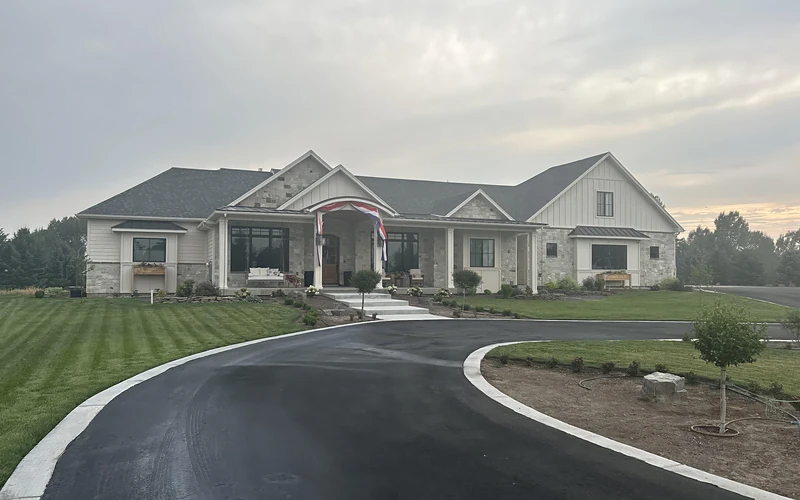 A completed custom home in stone and board and batten